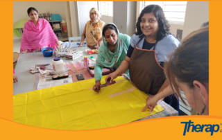 A special need girl is showing printing skill in a dress to Therap team