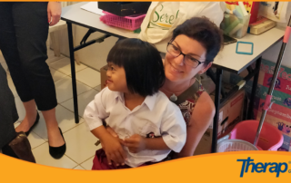Therap team member Maureen Noonan took a special need child in her arms at YPAC BALI